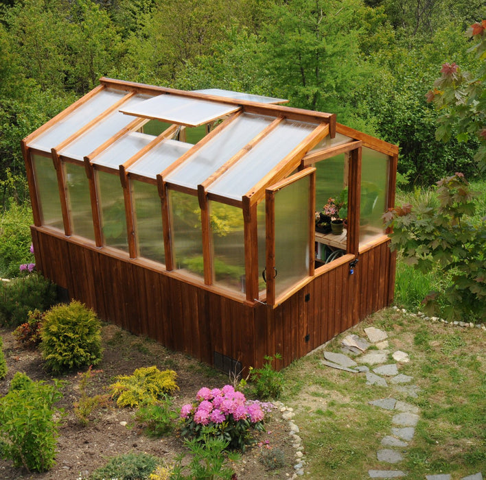 Cedar Greenhouse 8×12 with a pathway and lush green overhead view