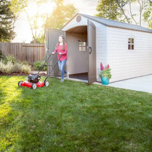 Lifetime 8x15 Outdoor Storage Shed 60075 woman pushing a lawnmower